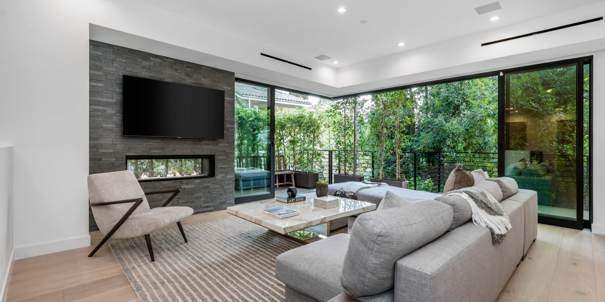 Spacious living room with oversized sofas, center table, and cozy fireplace